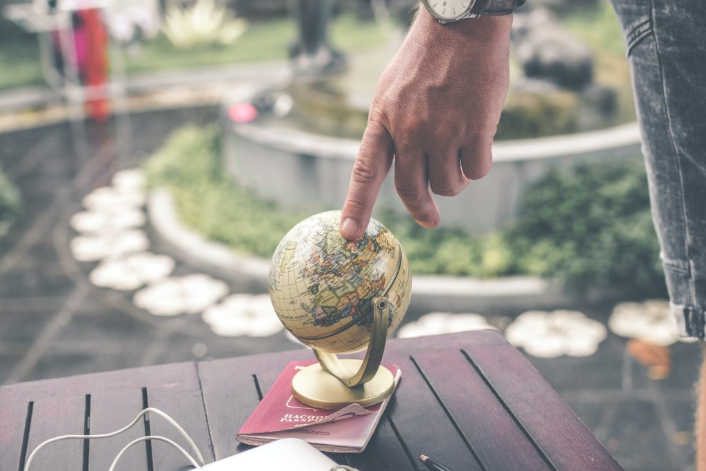 language translation services represented by hand touching a globe
