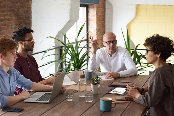 Members of an international business in a meeting, illustrating the impact that cultural differences can have