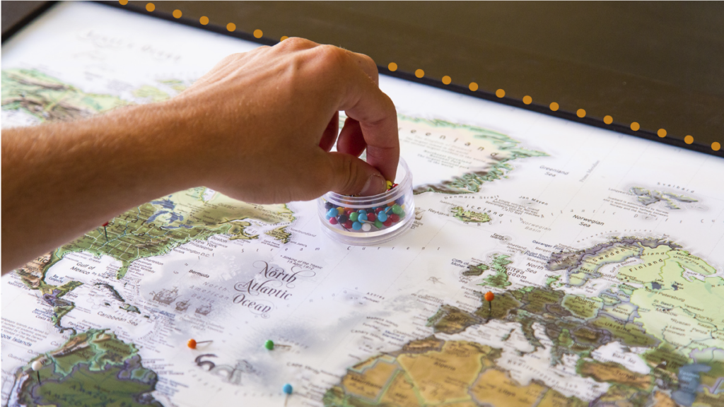 A photo of a person pinning countries on a world map representing international website expansion