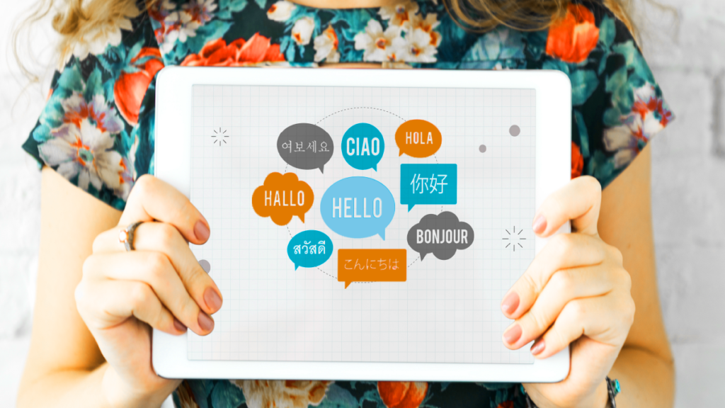 A woman holding a sheet where the word hello appears written in the most popular languages