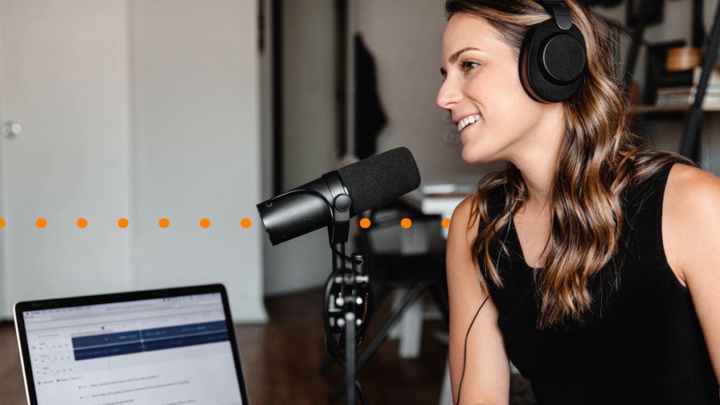 A woman recording a podcast, which highlights the importance of podcast transcription services
